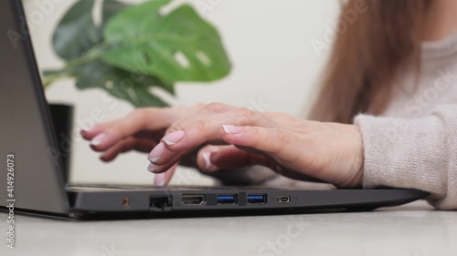 Hands on keyboard. Freelancer is a busy worker working with modern portable device. Business woman, working on laptop at home. close-up. Professional woman using a computer, works well.