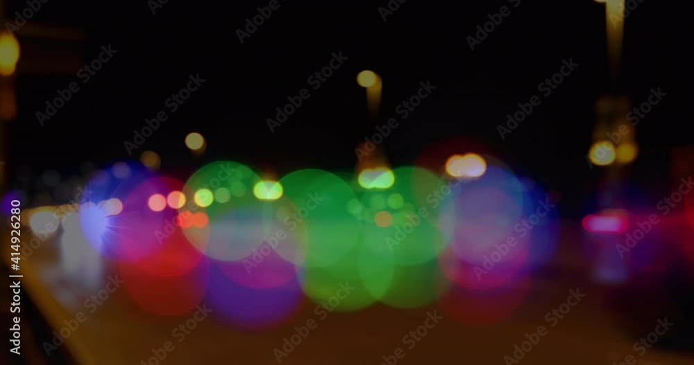 Animation of glowing vibrant spots of light over out of focus road traffic Animation of glowing vibrant spots of light over out of focus road traffic