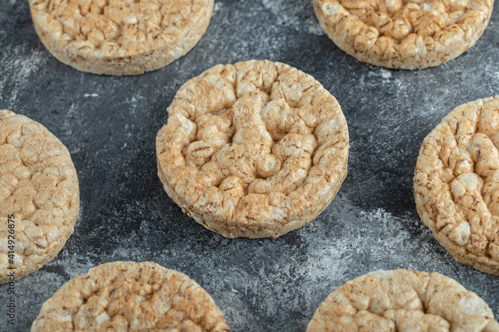 Sprinkled crispy rice cakes on marble background Sprinkled crispy rice cakes on marble background