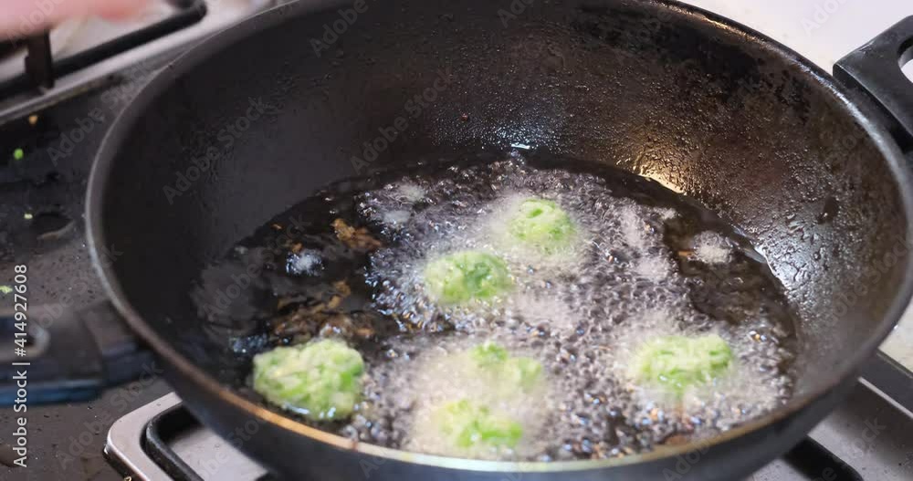 close up hand frying meatballs in oil. Traditional Chinese food close up hand frying meatballs in oil. Traditional Chinese food