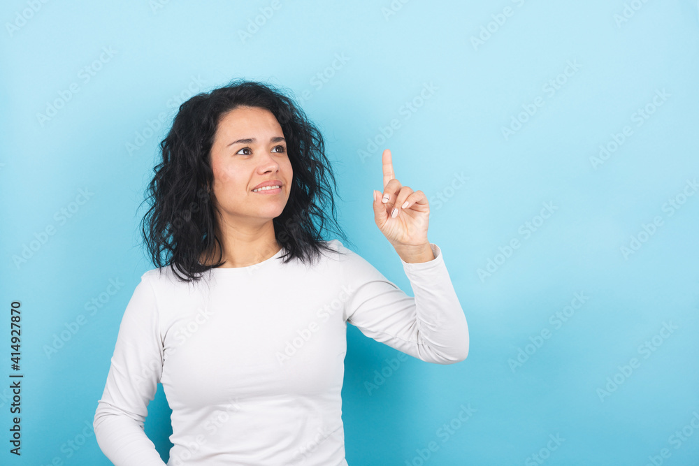 a young brunette girl points to a space for advertisement a young brunette girl points to a space for advertisement