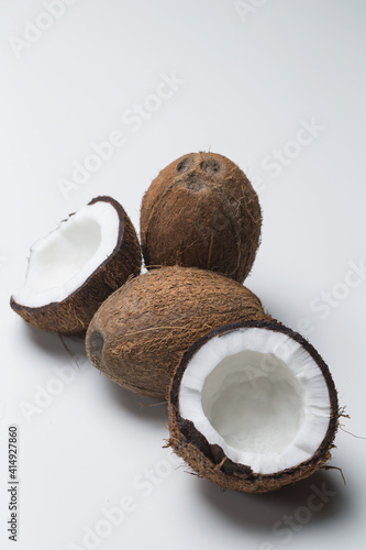 Whole and broken coconuts in studio