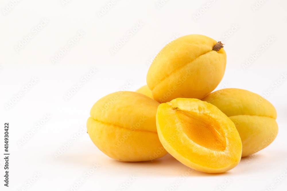 Yellow apricots on white background