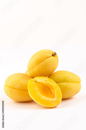 Yellow apricots on white background