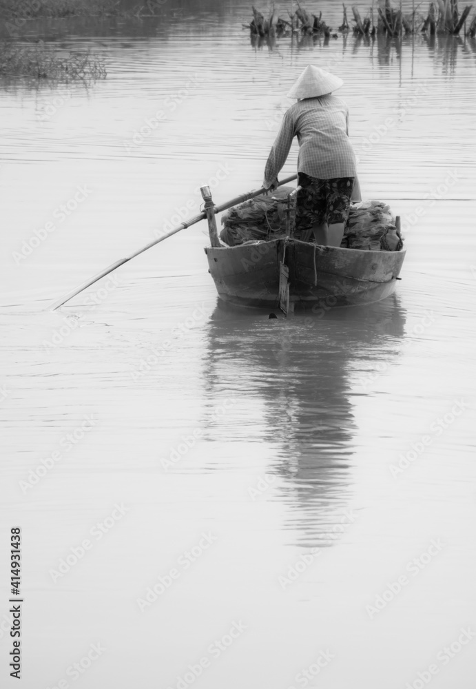 vietnamese woman on fishing boat cruising Danang river