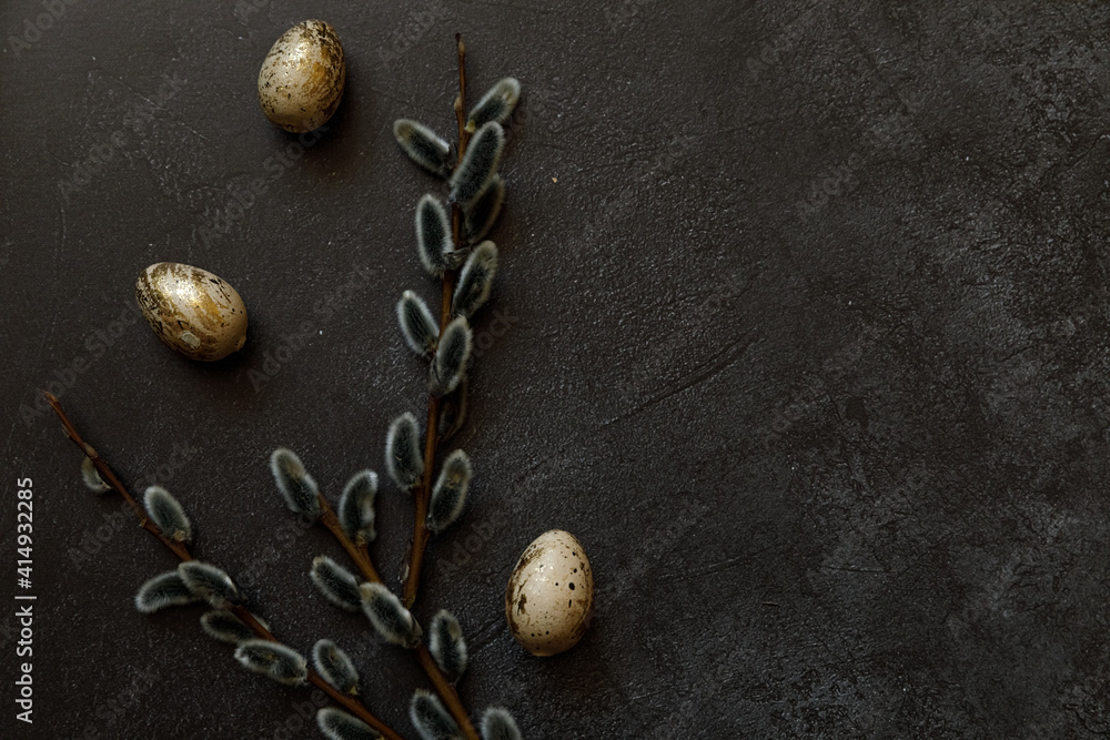 Happy Easter concept. Preparation for holiday. Golden decorated easter eggs willow on trendy grunge scratched dark black shale background. Simple minimalism flat lay top view, copy space Happy Easter concept. Preparation for holiday. Golden decorated easter eggs willow on trendy grunge scratched dark black shale background. Simple minimalism flat lay top view, copy space