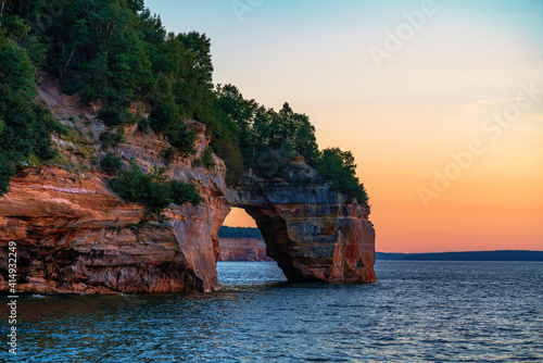 Sun sets on a natural arch at Pictured Rocks, National Lakeshore, Michigan.
