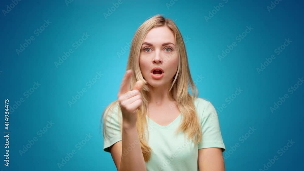 Blonde woman thinking over smart idea, pondering, against blue background Blonde woman thinking over smart idea, pondering, against blue background