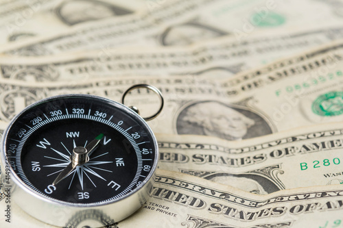 Compass with US dollar notes
