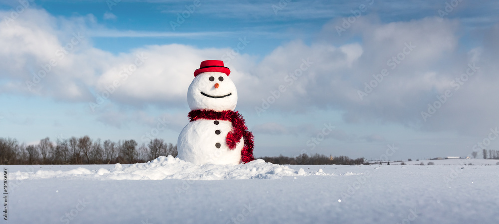 Funny snowman in stylish red hat and red scalf on snowy field. Panoramical photo ideal for site head mockup Funny snowman in stylish red hat and red scalf on snowy field. Panoramical photo ideal for site head mockup