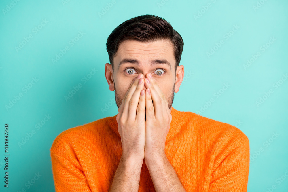 Photo of young man close cover face hands amazed shocked scared terrified afraid isolated over teal color background Photo of young man close cover face hands amazed shocked scared terrified afraid isolated over teal color background