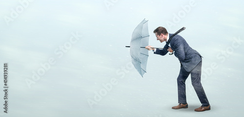 Businessman defying strong headwind photo
