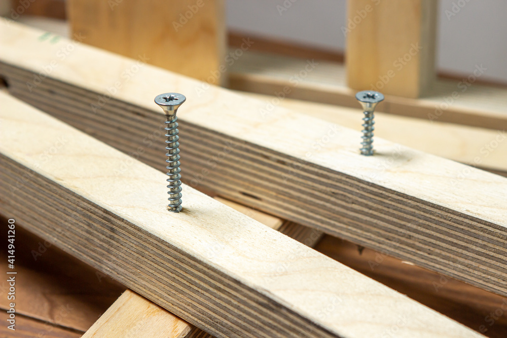 Woodwork. Wooden slats fastened together. Selftapping screw screwed into a wooden lath. Stock