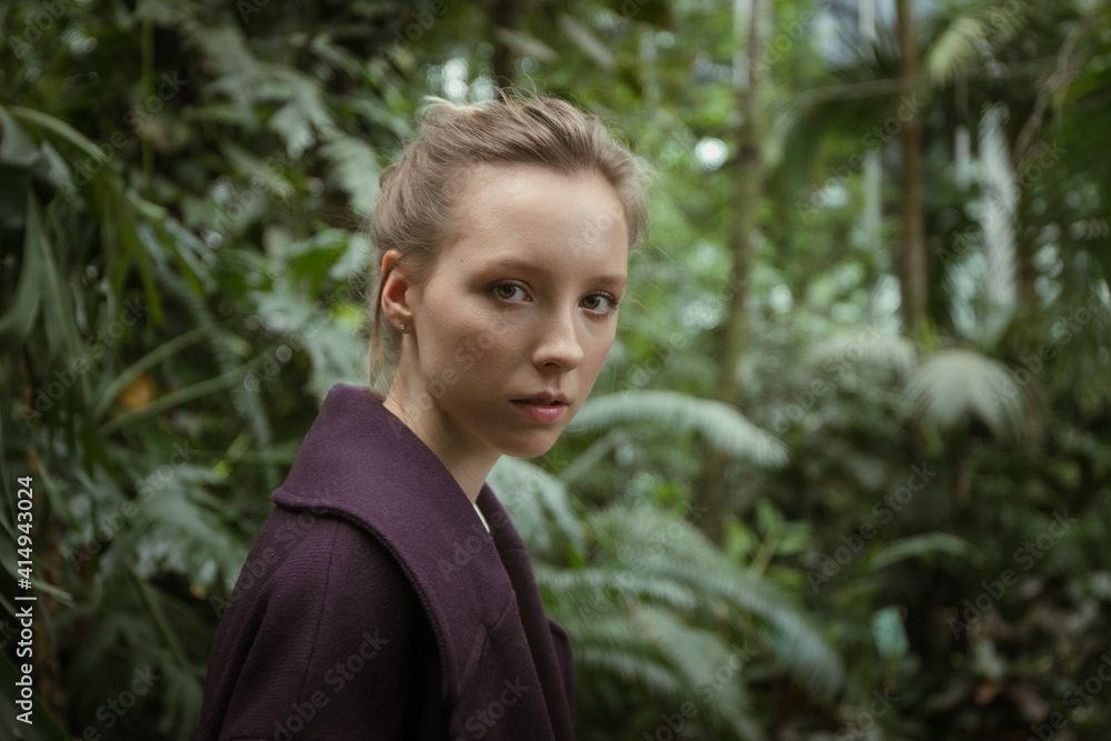 Portrait of a teenage girl in a greenhouse, close-up Portrait of a teenage girl in a greenhouse, close-up