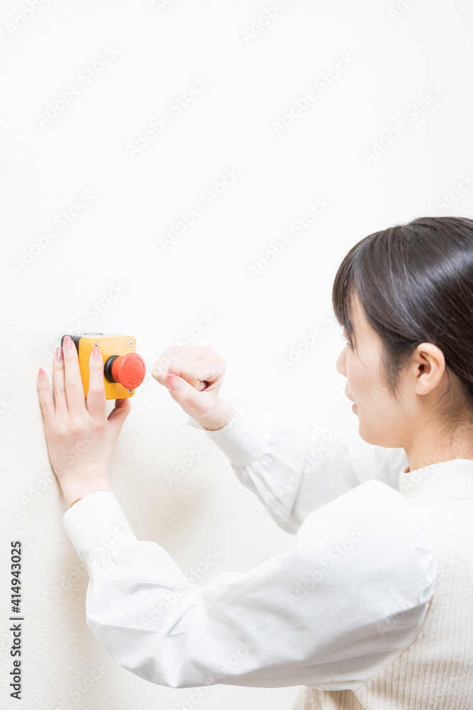 Woman trying to press the emergency switch Woman trying to press the emergency switch