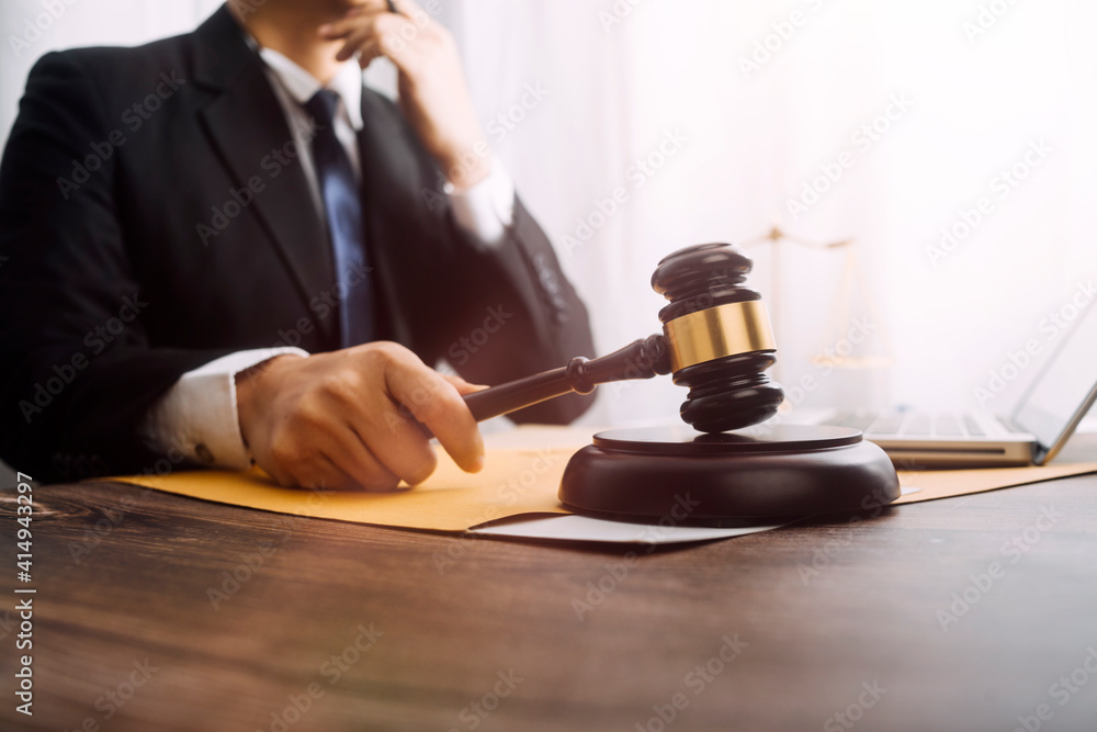 Business and lawyers discussing contract papers with brass scale on desk in office. Law, legal services, advice, justice and law concept picture with film grain effect Business and lawyers discussing contract papers with brass scale on desk in office. Law, legal services, advice, justice and law concept picture with film grain effect