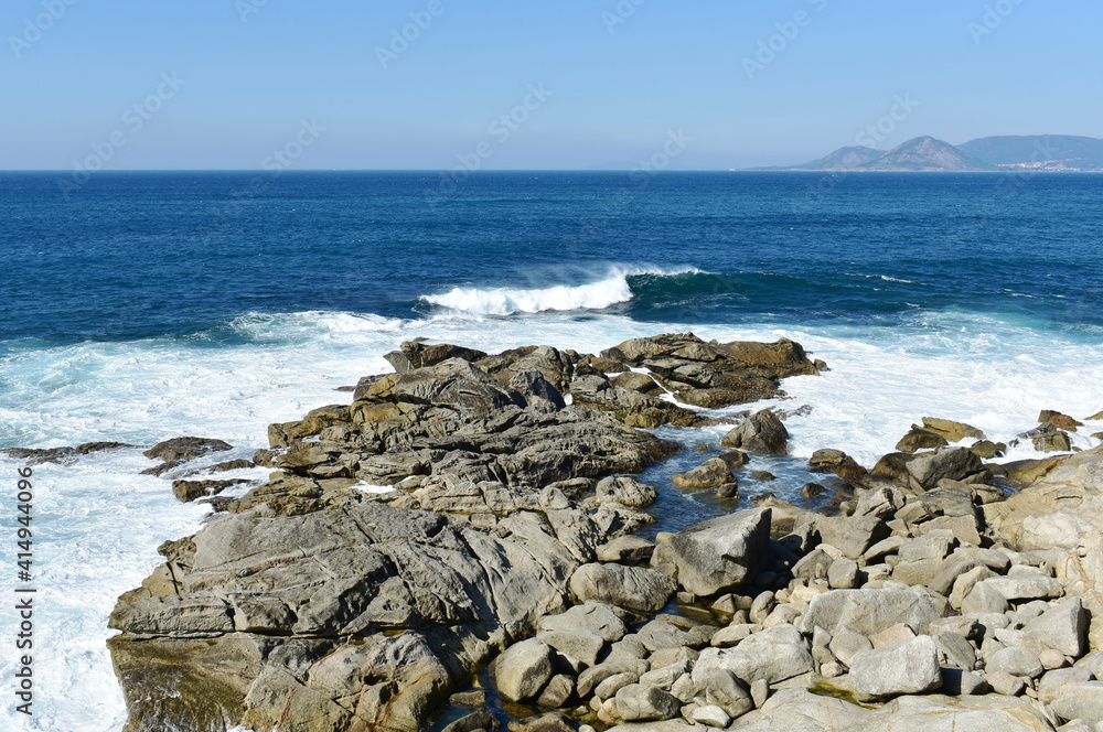 View from a cliff with waves breaking at famous Rias Baixas in Galicia Region. Porto do Son, Coruña, Spain.