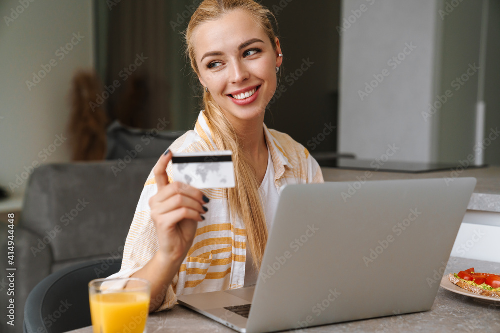 Smiling attractive young woman shopping online