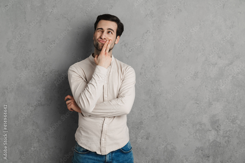 Handsome young man in casual outfit looking up isolated Handsome young man in casual outfit looking up isolated