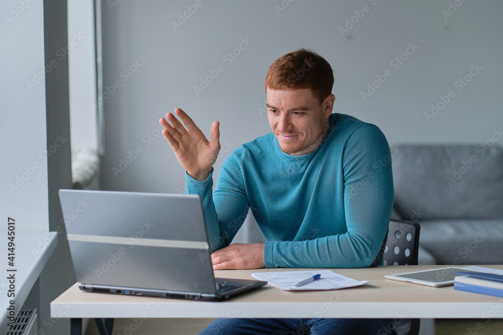 Business man having video call on laptop computer. Focused millennial man working in modern office or studying online at home. Business man having video call on laptop computer. Focused millennial man working in modern office or studying online at home.