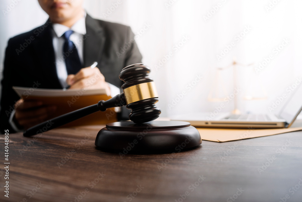 justice and law concept.Male judge in a courtroom on wooden table and Counselor or Male lawyer working in office. Legal law, advice and justice concept. justice and law concept.Male judge in a courtroom on wooden table and Counselor or Male lawyer working in office. Legal law, advice and justice concept.