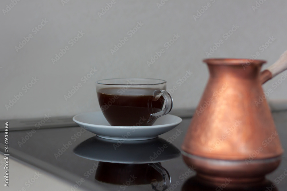 Fragrant black coffee is on the stove. Breakfast with coffee. Make coffee in a turk. Space for the text. Fragrant black coffee is on the stove. Breakfast with coffee. Make coffee in a turk. Space for the text.