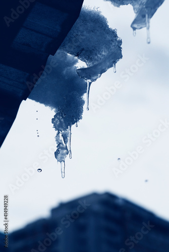 Melting icicle on the roof - view from the window. 