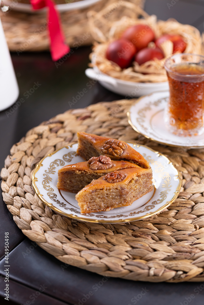 Novruz pastry pakhlava, Azerbaijan national holiday, ethnic cuisine eastern desserts for spring equinox celebration in white and golden plate. Persian nooruz sweets, copy space Novruz pastry pakhlava, Azerbaijan national holiday, ethnic cuisine eastern desserts for spring equinox celebration in white and golden plate. Persian nooruz sweets, copy space