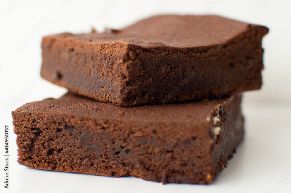 Pieces of fresh home-made brownie on white background. Delicious chocolate pie close-up isolated tasty cake. Pieces of fresh home-made brownie on white background. Delicious chocolate pie close-up isolated tasty cake.