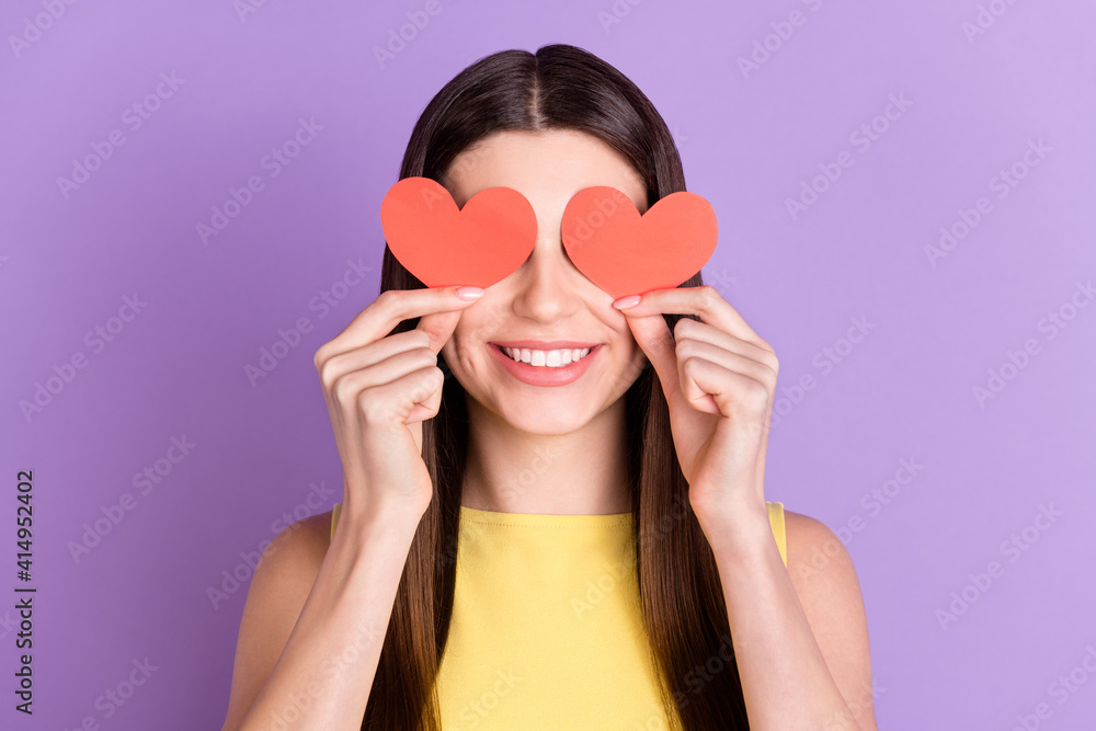Portrait of attractive cheerful girl holding in hands heart shape closing eyes having fun isolated over violet purple pastel color background Portrait of attractive cheerful girl holding in hands heart shape closing eyes having fun isolated over violet purple pastel color background