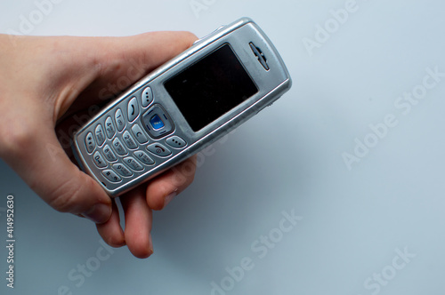 Wallpaper Mural Old 2000s phone in hand. Nostalgia retro phone.  Torontodigital.ca