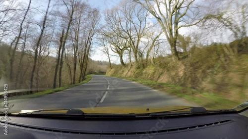 Point of view of car driving on country road in the French Basque Country, camera mounted inside the car on windscreen