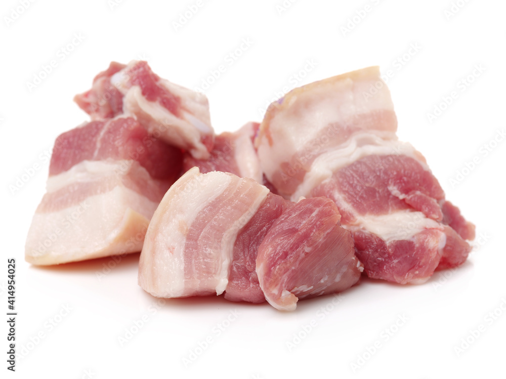 Raw pork belly pieces on a white background