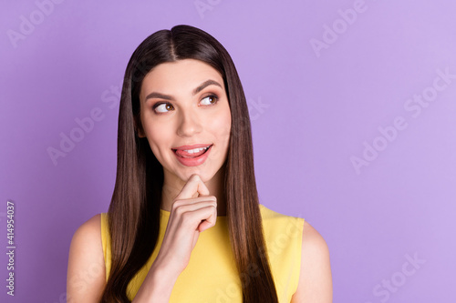 Portrait of attractive cheerful curious girl licking lip thinking copy space isolated over violet purple pastel color background