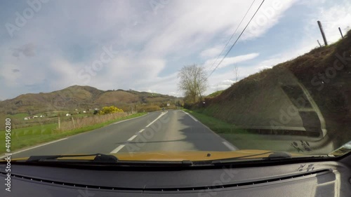 Point of view of car driving on country road in the French Basque Country, camera mounted inside the car on windscreen