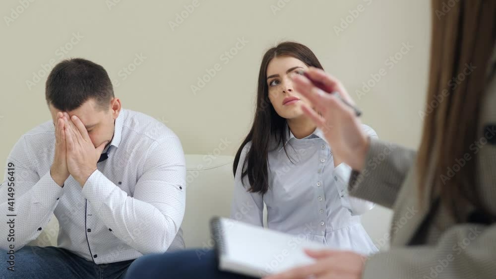 Unhappy couple talking to a psychologist before breaking up at a therapy session, consulting family relationships expert Unhappy couple talking to a psychologist before breaking up at a therapy session, consulting family relationships expert