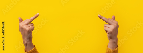 The double fuck you hand sign, female hands showing middle fingers gesturing