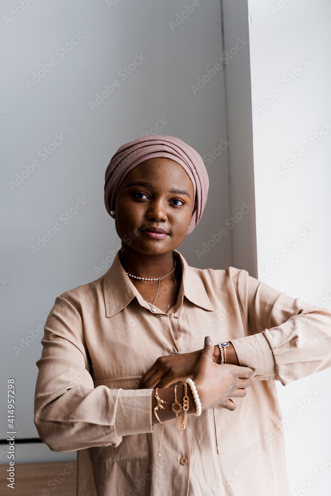 Muslim black girl on white background. African business woman in studio