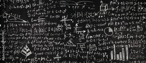 Blackboard inscribed with scientific formulas and calculations in physics and mathematics, background image