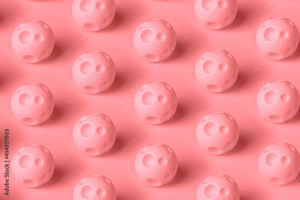 mars pattern over pink background, toy ball with craters on a bright background mars pattern over pink background, toy ball with craters on a bright background