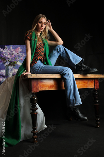 girl sitting on a table with a scarf