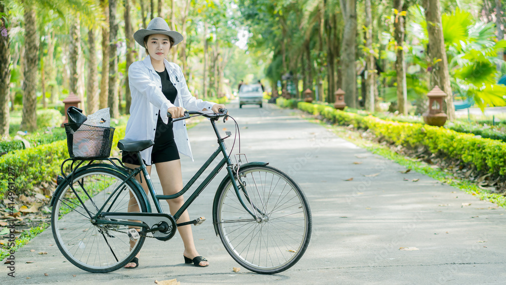 Young women, tourists, cycling in Sathan Park.