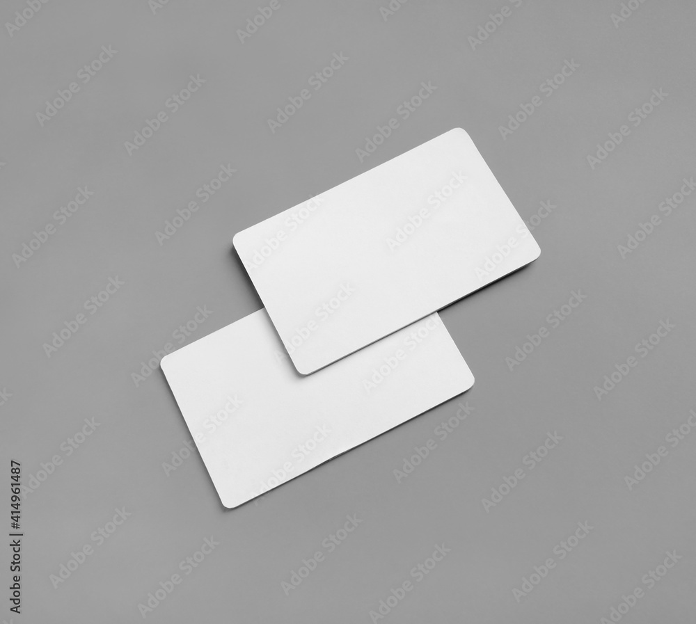 Blank business cards mockup on gray background. Copy space for text. Blank business cards mockup on gray background. Copy space for text.