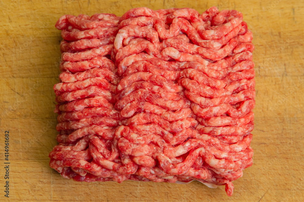 Red minced beef with chunks of fat on a chopping board Red minced beef with chunks of fat on a chopping board