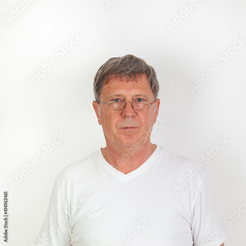 portrait of serious looking man with reading glasses, © travelview
