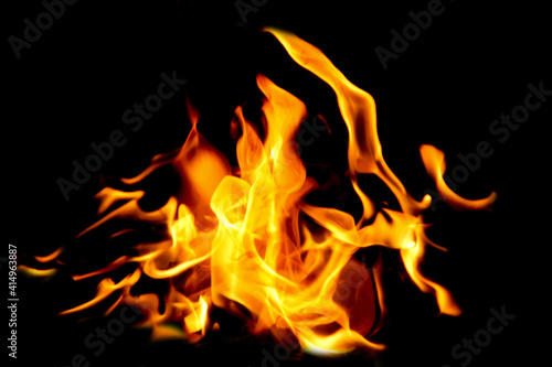 Fire flames on black background. The fire in the natural forest, flames and sparks on a dark background Fuel / lights on a black background. © somchai