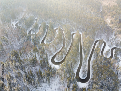 Aerial view of a snow-covered forest road