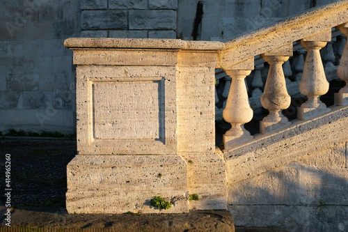 The beginnig of an outdoor white ancient stone staircase at the sunset photo