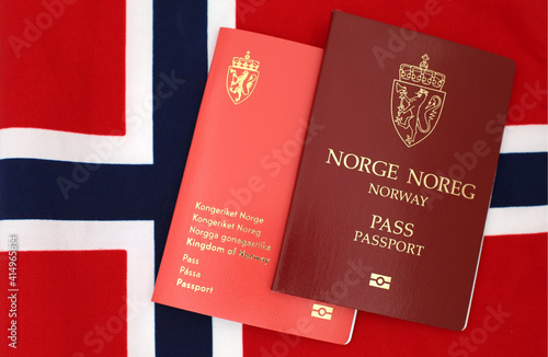 Drammen, Norway - January 2 2021 - Norwegian passports (New and Old design) on Norway flag.
