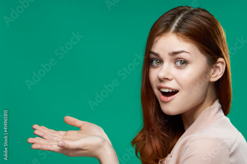cheerful woman gesturing with her hands emotions green background studio